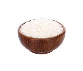 Uncooked dry rice in wooden bowl isolated