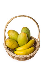 Ripe mangoes and bananas in the basket on isolated white