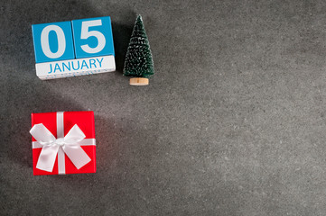 January 5th. Image 5 day of January month, calendar with x-mas gift and christmas tree. New year background with empty space for text, mockup