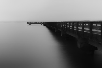stark black and white fishing pier