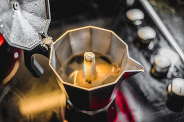 Italian Aluminum Coffee Maker Brewing a Fresh Dark Coffee on the Stove