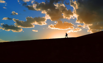 Hiker in silhouette at sunset