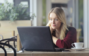 Blonde girl using a laptop
