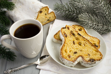Coffee and traditional stollen on the grey wooden background