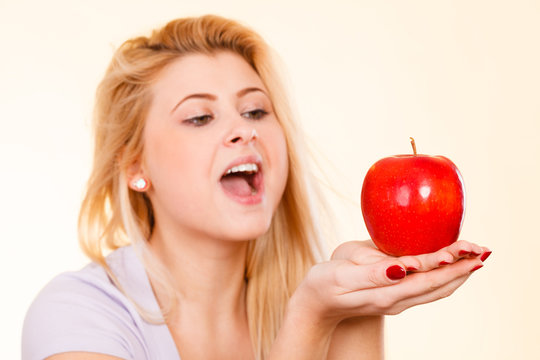 Woman holding red apple, healthy food concept