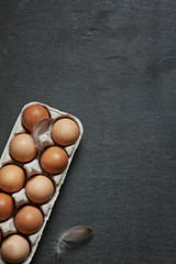Natural chicken eggs on rustic wooden background. Close-up, top view, copy space for your text