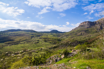 Fototapeta na wymiar colorful green valley on a sunny day on the horizon ridge, walk in the mountains open perceptiv