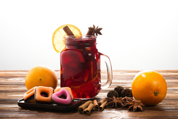 The glass of hot mulled wine with cinnamon, oranges, cranberries and anise. Space for text or...