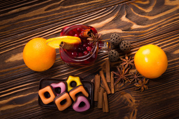 The glass of hot mulled wine with cinnamon, oranges, cranberries and anise. Space for text or design.