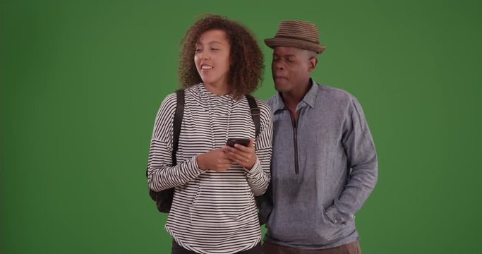 Close-up of African American millennial guy and girl with curly hair  on green screen. On green screen to be keyed or composited. 
