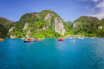 Fototapeta na wymiar Colored boats in the ocean bay near Phi Phi islands