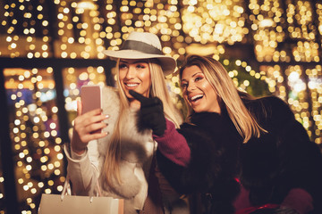 Two Sisters At The City In Holiday Time