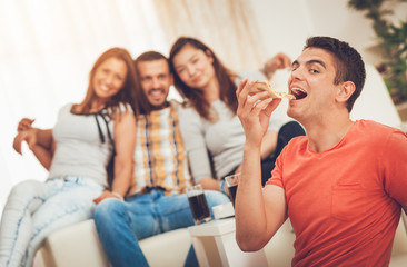 Young Man Eating Pizza