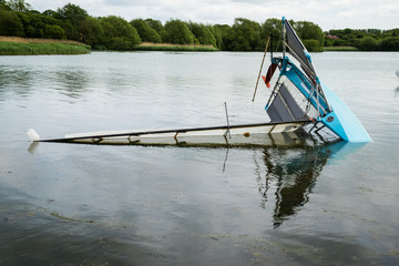 Capsized dinghy on Hornsea Mere, Yorkshire, UK.