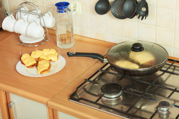 Frying chicken cutlet with pineapples and cheese.