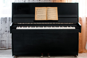 Fototapeta na wymiar Black piano with notes