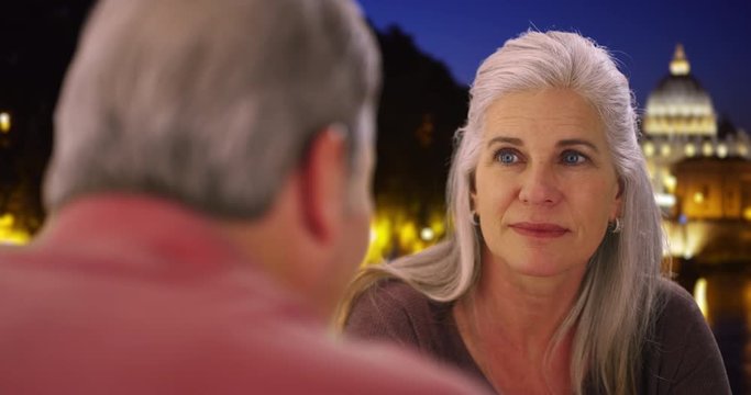 Elderly white male and female have conversation on evening in Rome near Vatican