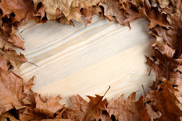autumn leaves on wooden background flat view copy space