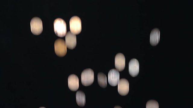 Metal coins fall on a black background. Closeup. Slow mo, slo mo, slow motion, high speed camera, 240fps, 250fps
