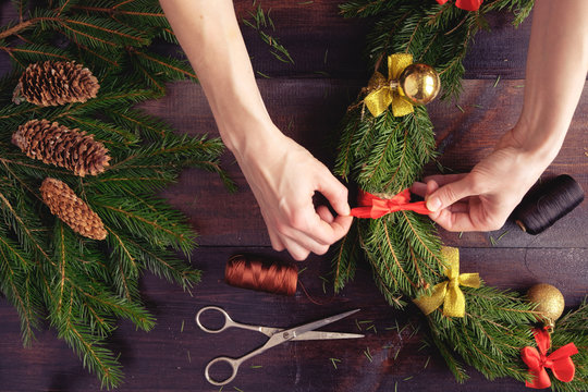 woman making christmas wreath hands close up flat view