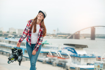 Young woman with roller skates outdoors active lifestyle