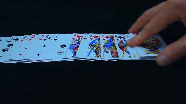 Hand lay out playing cards on a white background. Closeup. Slow mo, slo mo, slow motion, high speed camera, 240fps, 250fps