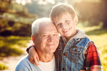 Grandfather and grandson together outdoors family concept