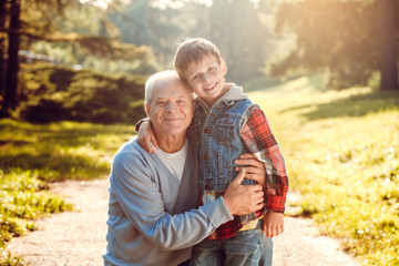 Fototapeta premium Grandfather and grandson together outdoors family concept