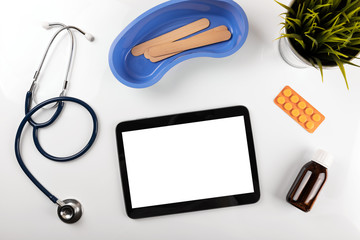 medical supplies with blank digital tablet on white background. top view