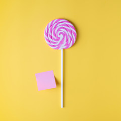 Valentine's day bright yellow background, greeting card concept,  lollipop or sweet candy on sticks with stiker