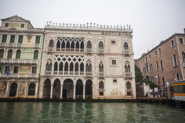 Fototapeta na wymiar Famous palaces on the Grand Canal in Venice, Italy. Moisture