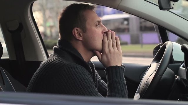 Depressed and very upset young man in the car. problems in business or personal life