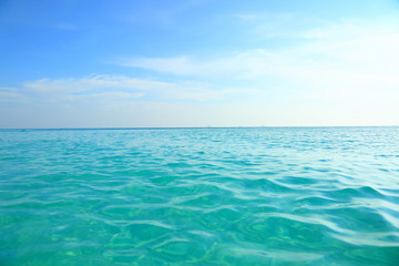 Fototapeta na wymiar Turquoise sea water and blue sky. Beautiful background.