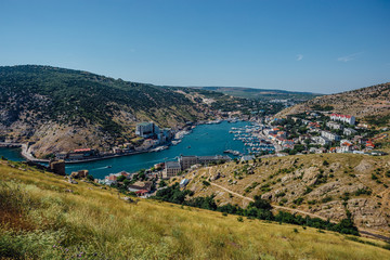 Fototapeta na wymiar Beautiful view of the Black Sea and Balaklava Bay. Panorama view to city, ships and port