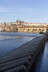Obraz premium View on the winter Prague gothic Castle with the Charles Bridge in the sunny Day, Czech Republic