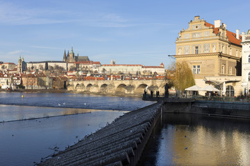 View on the winter Prague gothic Castle with the Charles Bridge in the sunny Day, Czech Republic