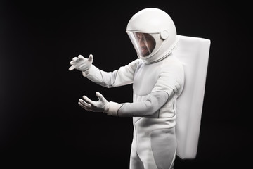 New discovery. Side view of concentrated young astronaut wearing specialized protective suit and...
