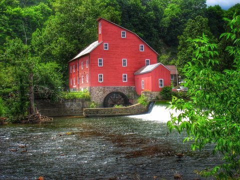Historic Red Mill Clinton New Jersey with water wheel and waterfall with rich color