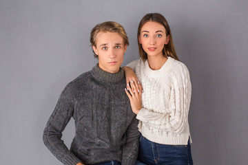 Young couple studio isolated on grey wall concept