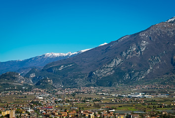 Fototapeta na wymiar Beautiful panoramic view on the snowy mountains near Lake Garda and Arco Castle, Italy