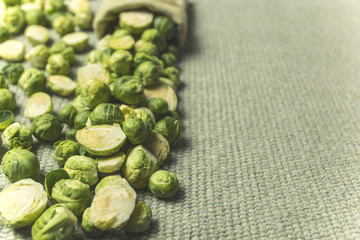 A close-up of Brussels sprouts scattered from a bag.