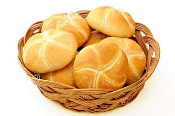 Fresh baked rolls in a basket on white
