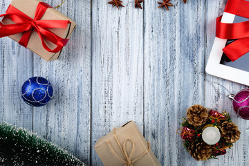 Presents wrapped with red ribbon and new year's attributes on vintage wooden background