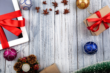 Presents wrapped with red ribbon and new year's attributes on vintage wooden background