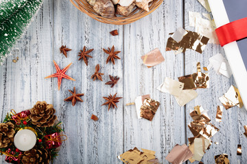 Christmas objects cones, christmas tree, candle, star, gift wraped with a red ribbon and tinsel