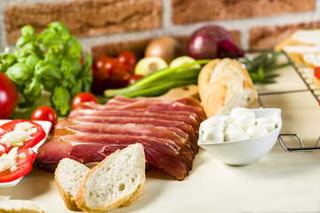 bruschetta with tomatoes, mozzarella, Parma ham and basil