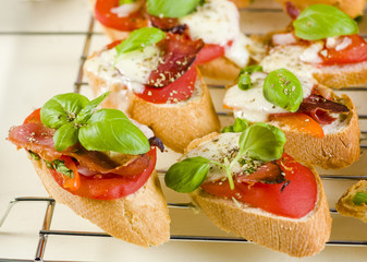 bruschetta with tomatoes, mozzarella, Parma ham and basil