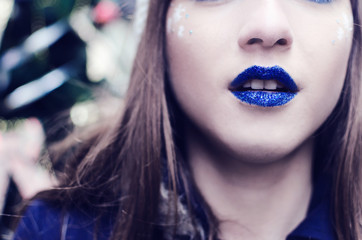 Woman with blue tinsel lipstick