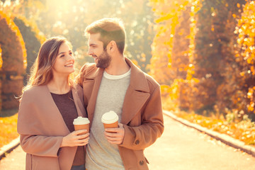 Young couple walk in the autumn park