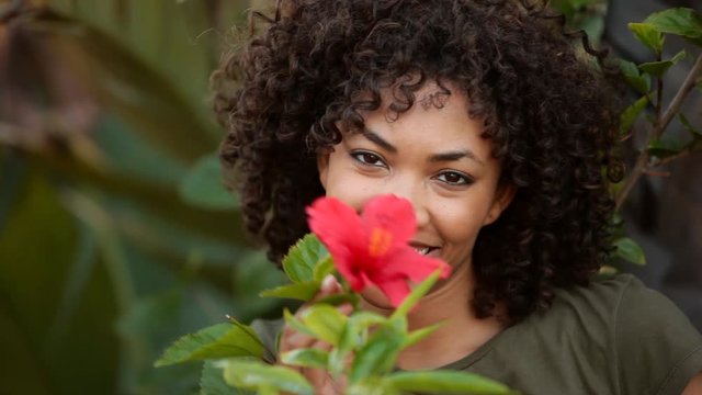 Young woman posing with flower